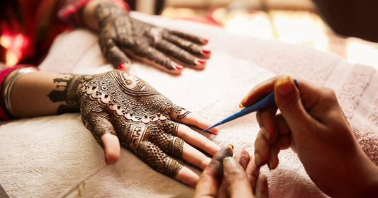 close up image of applying Mehendi designs