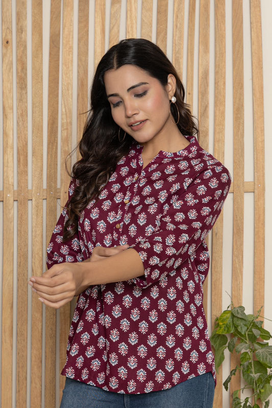 V- NECK BERRY COLOR SHORT KURTI WITH WHITE ABSTRACT PRINT, WITH FALSE BUTTONS AT NECK AND REGULAR 3/4th SLEEVE WITH ROUND HEAM LINE