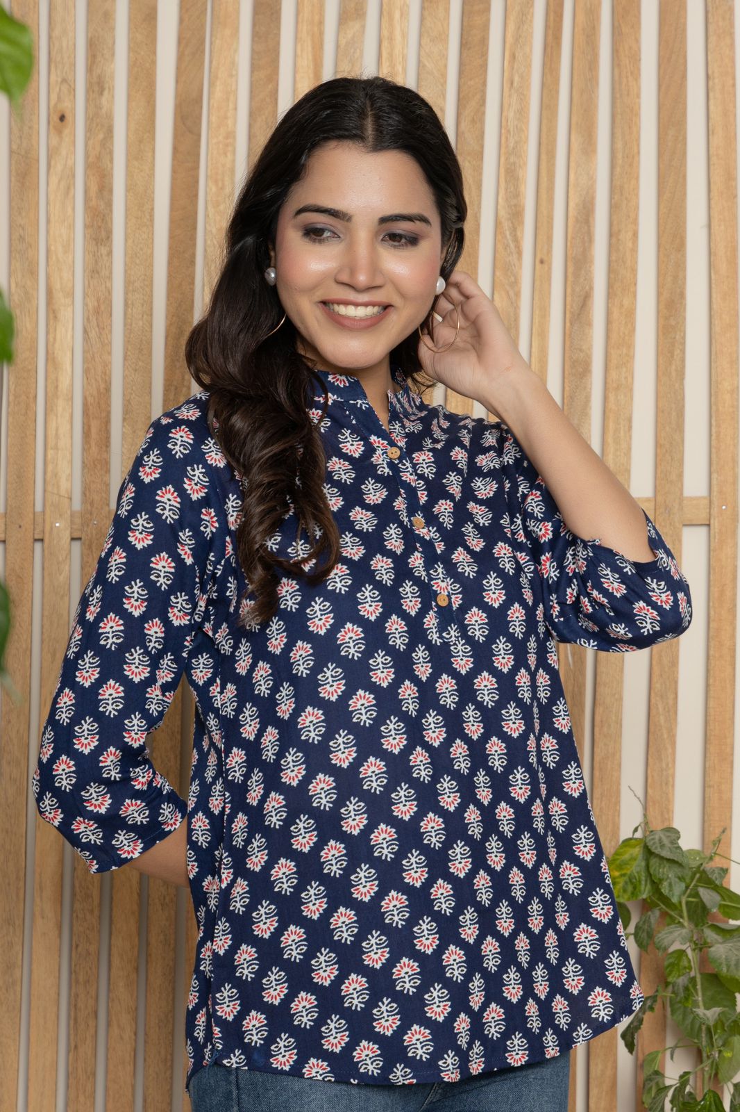 V- NECK INDIGO COLOR SHORT KURTI WITH WHITE&RED ABSTRACT PRINT, WITH FALSE BUTTONS AT NECK AND REGULAR 3/4th SLEEVE WITH ROUND HEAM LINE