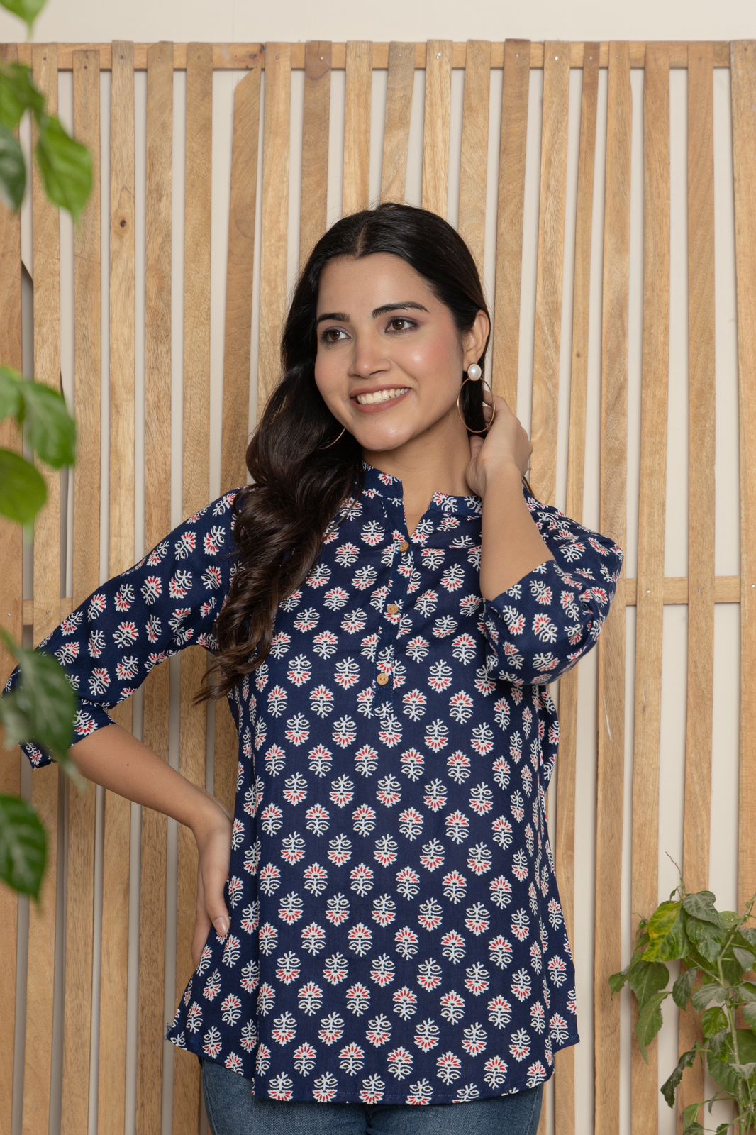 V- NECK INDIGO COLOR SHORT KURTI WITH WHITE&RED ABSTRACT PRINT, WITH FALSE BUTTONS AT NECK AND REGULAR 3/4th SLEEVE WITH ROUND HEAM LINE